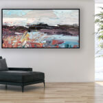 Abstract landscape painting, original oil painting on canvas hanging in a modern living room with a black sofa