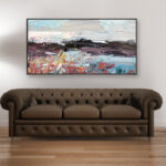 Abstract landscape painting, original oil painting on canvas hanging in a modern living room with a brown sofa