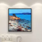 Original Impressionist Oil Painting on Canvas of a Sardinian Beach hanging in a modern living room with a white sofa and home decor