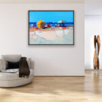 Beach oil painting on canvas with rich impasto texture hanging in a modern living room with a beige sofa