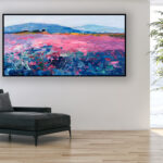 Landscape painting with lavender, original oil painting on canvas hanging in a modern living room with a black sofa