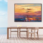 Sunset painting, original oil painting on canvas hanging in a modern living room with a table and ocean view