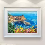 Vernazza Cinque Terre painting with cactus and flowers, original oil painting on canvas hanging in a modern living room with a white sofa and home decor