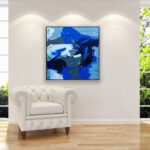 Abstract painting, original oil painting on canvas hanging in a modern living room with a white sofa and home decor