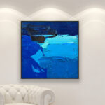 Abstract painting, original oil painting on canvas hanging in a modern living room with a white sofa and home decor