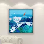 Ocean painting with sailboat, original oil painting on canvas hanging in a modern living room with a white sofa and home decor