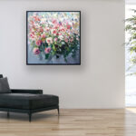 White and Pale Pink Roses painting on canvas hanging in a modern living room with a black sofa and home decor