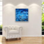 Blue Abstract oil painting on canvas with rich impasto texture hanging in a modern living room with a white sofa, showing full room decor.