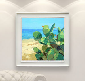 Modern oil painting on canvas of a beach with cacti hanging in a modern living room with a white sofa and home decor