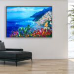 Positano painting with flowers and cactus, original oil painting on canvas hanging in a modern living room with a black sofa