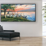 Seascape Painting at Sunset, original oil painting on canvas hanging in a modern living room with a black sofa