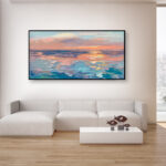 Abstract sunset painting, original oil painting on canvas hanging in a modern living room with a white sofa