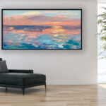 Abstract sunset painting, original oil painting on canvas hanging in a modern living room with a black sofa