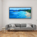 Beach painting, original oil painting on canvas hanging in a modern living room with a gray sofa