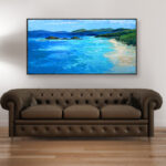 Beach painting, original oil painting on canvas hanging in a modern living room with a beige sofa