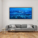 Blue ocean painting, original oil painting on canvas hanging in a modern living room with a gray sofa