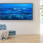 Blue ocean painting, original oil painting on canvas hanging in a modern living room with a blue sofa