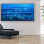 Blue ocean painting, original oil painting on canvas hanging in a modern living room with a black sofa