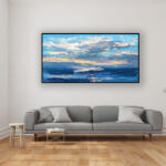 Abstract sunset painting, original oil painting on canvas hanging in a modern living room with a gray sofa