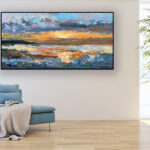 Sunset painting, original oil painting on canvas hanging in a modern living room with a blue sofa
