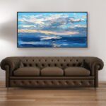 Abstract sunset painting, original oil painting on canvas hanging in a modern living room with a brown sofa