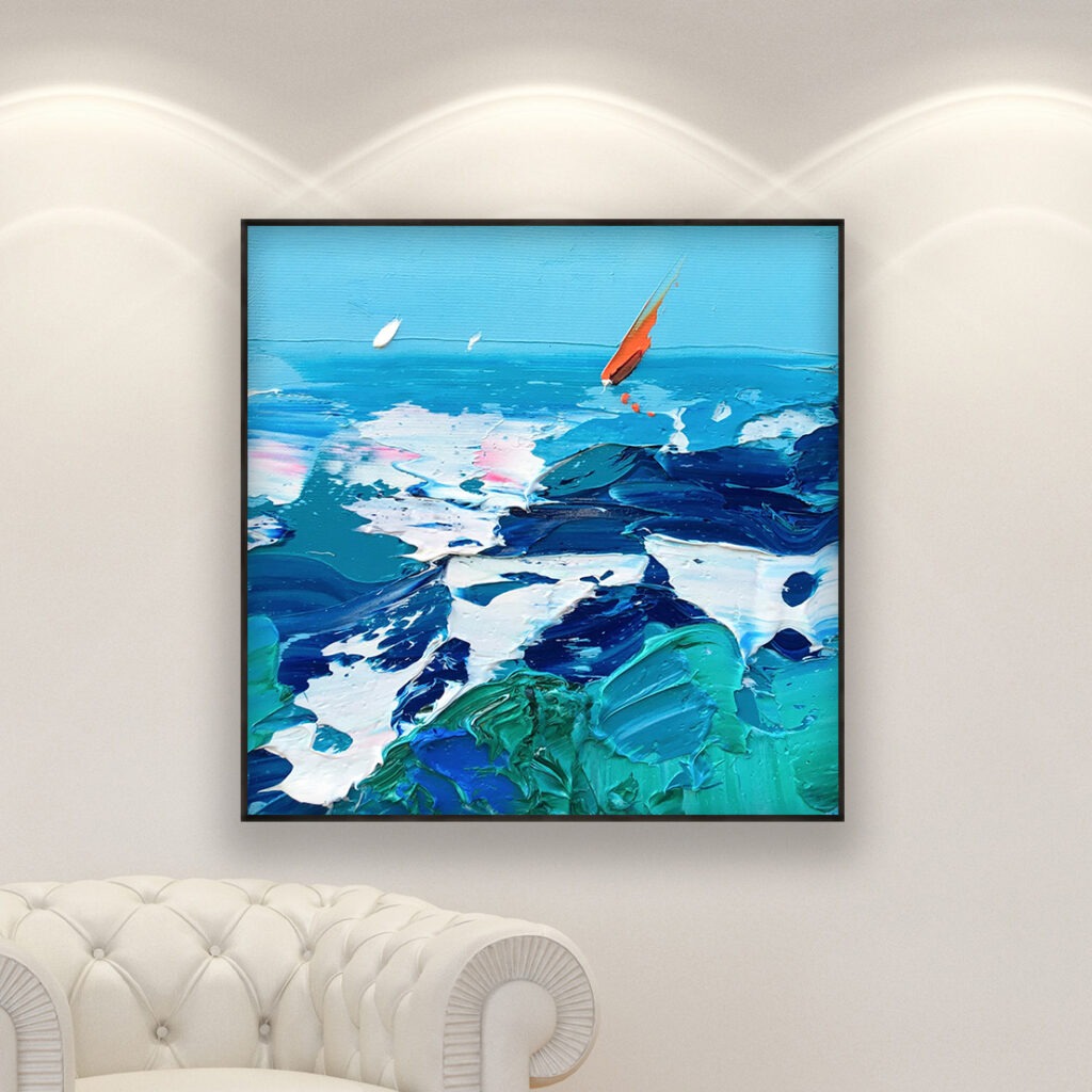 Ocean painting with sailboat, original oil painting on canvas hanging in a modern living room with a white sofa and home decor